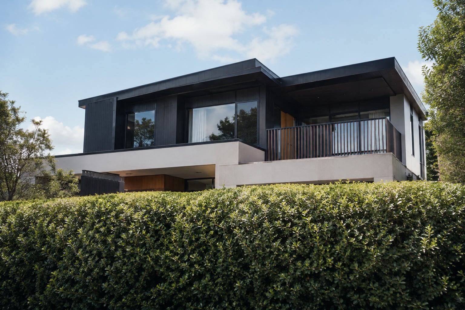 Modern house behind hedge